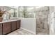 A well-lit bathroom featuring stylish shower, modern cabinets, and a sleek white countertop at 18938 W Luke Ave, Litchfield Park, AZ 85340