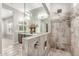 Beautiful bathroom featuring a shower with elegant tile work and modern fixtures with natural lighting at 18938 W Luke Ave, Litchfield Park, AZ 85340