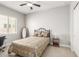 Cozy bedroom showcasing a comfortable bed, ceiling fan, and a window letting in natural light at 18938 W Luke Ave, Litchfield Park, AZ 85340