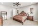 Spacious bedroom with ornate headboard, matching nightstands, and ceiling fan at 18938 W Luke Ave, Litchfield Park, AZ 85340