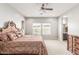 Bedroom with ceiling fan, dresser, and lots of natural light at 18938 W Luke Ave, Litchfield Park, AZ 85340