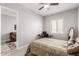 Bedroom featuring a comfortable bed, ceiling fan, and natural light from the window at 18938 W Luke Ave, Litchfield Park, AZ 85340