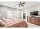 Bedroom with ceiling fan, dresser, and lots of natural light at 18938 W Luke Ave, Litchfield Park, AZ 85340