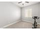 A bright bedroom featuring a window for natural light, with neutral carpeting and paint at 18938 W Luke Ave, Litchfield Park, AZ 85340