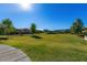 Expansive community green featuring mature trees and well-maintained grass, perfect for outdoor activities and relaxation at 18938 W Luke Ave, Litchfield Park, AZ 85340
