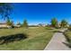 Well-manicured community green with walking path, landscaping, and homes offering a picturesque and inviting environment at 18938 W Luke Ave, Litchfield Park, AZ 85340