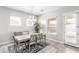 Bright dining room with elegant chandelier and ample natural light at 18938 W Luke Ave, Litchfield Park, AZ 85340