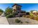 Elegant stone Windrose entrance with beautiful landscaping and inviting architecture at 18938 W Luke Ave, Litchfield Park, AZ 85340