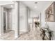 Open hallway with decorative console table and artwork, leading to the living areas at 18938 W Luke Ave, Litchfield Park, AZ 85340