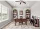 Bright home office featuring built-in bookshelves, large desk, and neutral paint at 18938 W Luke Ave, Litchfield Park, AZ 85340