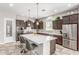 Spacious kitchen features large island, stainless steel appliances, and modern lighting at 18938 W Luke Ave, Litchfield Park, AZ 85340