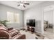 Inviting living room featuring a flat screen television, ceiling fan, and comfortable seating at 18938 W Luke Ave, Litchfield Park, AZ 85340