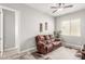 The living room featuring a comfy sofa, flat screen television, and ample natural light at 18938 W Luke Ave, Litchfield Park, AZ 85340