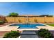 Beautiful backyard pool with stone accents, desert landscaping, and privacy fence at 18938 W Luke Ave, Litchfield Park, AZ 85340