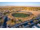 Aerial view of neighborhood featuring large, green, park in the middle of a circle of trees at 21397 S 215Th Way, Queen Creek, AZ 85142