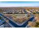 Aerial view of suburban neighborhood and park showcasing well-maintained streets and green spaces at 21397 S 215Th Way, Queen Creek, AZ 85142