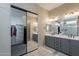 Bathroom with double vanity, modern lighting fixtures, and a walk-in closet, designed for comfort at 21397 S 215Th Way, Queen Creek, AZ 85142