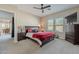 Spacious bedroom featuring plush carpet, a ceiling fan, and large windows for ample natural light at 21397 S 215Th Way, Queen Creek, AZ 85142