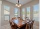 Bright dining room featuring a wood table, chairs, and multiple windows with blinds at 21397 S 215Th Way, Queen Creek, AZ 85142