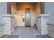 Charming front porch with stone pillars, a welcoming front door, and decorative lighting at 21397 S 215Th Way, Queen Creek, AZ 85142