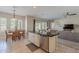 Open kitchen with island and stainless steel appliances adjacent to a dining and living area at 21397 S 215Th Way, Queen Creek, AZ 85142