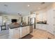 Open kitchen featuring a center island, stainless steel appliances, and adjacent living area at 21397 S 215Th Way, Queen Creek, AZ 85142