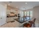 Open kitchen featuring white cabinets, granite countertops, stainless steel appliances, and a breakfast bar at 21397 S 215Th Way, Queen Creek, AZ 85142