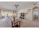 Spacious living room with plush sofa, carpet, ceiling fan, and sliding glass doors at 21397 S 215Th Way, Queen Creek, AZ 85142