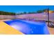 Modern pool and patio featuring beautiful stonework, a basketball hoop, and privacy landscaping at 21397 S 215Th Way, Queen Creek, AZ 85142