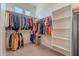 A walk-in closet with ample hanging space and shelving, designed for maximum organization at 21397 S 215Th Way, Queen Creek, AZ 85142