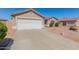 Charming single-story home with a spacious driveway and low-maintenance desert landscaping in the front yard at 2142 E Wildhorse Dr, Chandler, AZ 85286