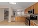 Well-lit kitchen with stainless steel appliances, wooden cabinets, and an adjacent breakfast bar at 2142 E Wildhorse Dr, Chandler, AZ 85286