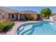 Beautiful backyard pool with steps, surrounded by lush landscaping and a covered patio area at 2142 E Wildhorse Dr, Chandler, AZ 85286