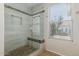 Modern tiled shower with a built-in bench, glass door and a window offering natural light at 2142 E Wildhorse Dr, Chandler, AZ 85286