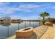 Waterfront backyard boasts a fire pit, mature landscaping and a tranquil view of the lake at 21609 N Diamond Dr, Maricopa, AZ 85138