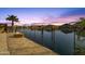 Lakeside backyard with a fire pit, privacy fence, and stunning views of the water at sunset at 21609 N Diamond Dr, Maricopa, AZ 85138