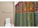 Compact bathroom with a vibrant shower curtain and efficient use of space at 21609 N Diamond Dr, Maricopa, AZ 85138