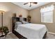 Cozy bedroom features a dark wood headboard with built-in storage and neutral decor at 21609 N Diamond Dr, Maricopa, AZ 85138