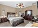 Cozy bedroom featuring a dark wooden bed frame, soft carpet, and an ensuite bath at 21609 N Diamond Dr, Maricopa, AZ 85138