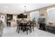 Bright dining area featuring an elegant light fixture, fish tank and views into the kitchen at 21609 N Diamond Dr, Maricopa, AZ 85138