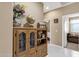 Hallway with a decorative cabinet, leading to the living room and bedroom at 21609 N Diamond Dr, Maricopa, AZ 85138