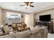 Comfortable living room boasts neutral tones and a view of the lake outside the window at 21609 N Diamond Dr, Maricopa, AZ 85138