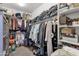 This walk-in closet maximizes space, featuring shelving and hanging rods for organization at 21609 N Diamond Dr, Maricopa, AZ 85138