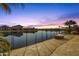 Scenic waterfront view with a fire pit and comfortable seating, perfect for enjoying peaceful evenings by the tranquil water at 21609 N Diamond Dr, Maricopa, AZ 85138