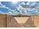 A large dirt backyard is enclosed by block fencing, showing desert landscaping potential at 2204 W Minton St, Phoenix, AZ 85041