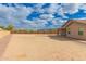 A large dirt backyard enclosed by block fencing, showing desert landscaping potential at 2204 W Minton St, Phoenix, AZ 85041