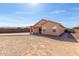 View of the back of the house with a large dirt backyard surrounded by block fencing at 2204 W Minton St, Phoenix, AZ 85041