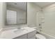 A bright bathroom features a vanity with a white countertop and a shower-tub combo at 2204 W Minton St, Phoenix, AZ 85041