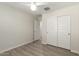 A spacious bedroom with wood-look tile, closet doors and a view into the hall at 2204 W Minton St, Phoenix, AZ 85041