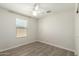 Bedroom with wood-look tile flooring, natural light, and a ceiling fan at 2204 W Minton St, Phoenix, AZ 85041